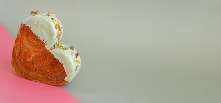 Creative isometric idea Valentines Day Holiday celebration Heart shaped croissants on two colored background with copy space. Puff pastry new trendy sweet dessert bakery. Creamy doughの写真素材