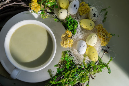 Happy Easter egg wreath decoration Sweet macaron dessert Cup of green plant based matcha tea latte in cozy morning atmosphere. Creative holiday romantic date idea. Herbal prebiotic fiber superfood beverage antioxidant-rich immunity-boosting coffee alternativesの写真素材