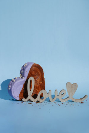LOVE word symbol card Heart shaped blueberry flavor croissant on blue background with copy space. Puff pastry new trendy sweet dessert bakery. Creamy doughの写真素材