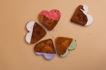 Creative ides Valentines Day flat lay top view Holiday celebration Heart shaped different variety flavor croissants on beige background with copy space. Puff pastry new trendy sweet dessert bakery. Creamy doughの写真素材