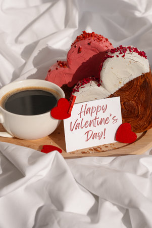 Happy Valentines Day wishes saying caption on greeting card Coffee breakfast in rumpled bedding bed with heartshaped pastry croissant treat. Food experimentation viral dessert baking trendの写真素材