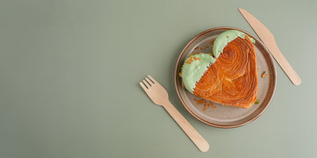 Delicious fresh croissant topped with Matcha Green Tea flavor Ganache on plate. Creation unique heart shape bakery. Puff pastry holiday love gift present idea Valentines dayの写真素材