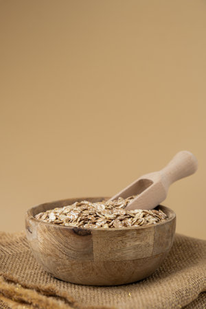 Raw oatmeal porridge in neutral beige background copy space. Whole spelt grain species. High protein...