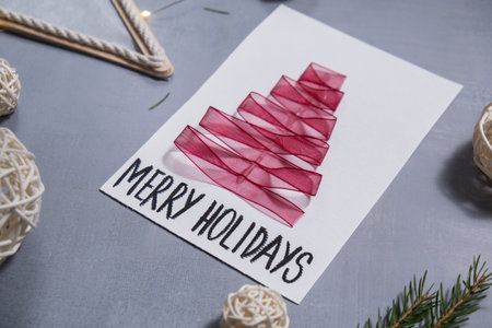 Christmas tree ribbon Gift Christmas idea. Do it yourself instruction postcard eco-friendly decoration. Making handmade presents childrens diy projects. Holiday family timeの写真素材