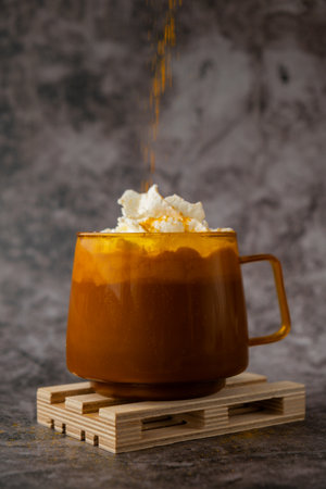 Autumn hygge Orange Cup of warm coffee autumn. Cozy fall still life dark background. Thanksgiving and Halloween holidayの写真素材