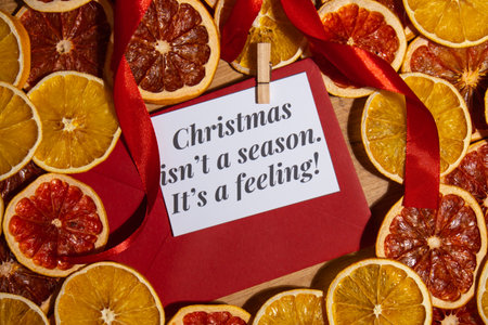 Greeting card with CHRISTMAS ISNT A SEASON ITS A FEELING text on handmade Christmas wreath. Festive mood new year celebration. Postcard decoration decorの写真素材