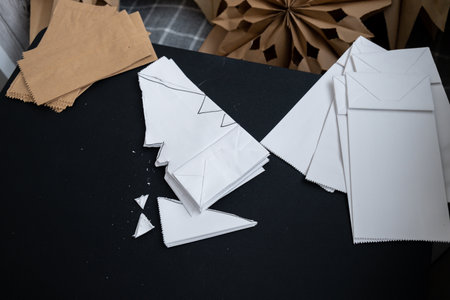 Process of preparing for Christmas star and New Year eve. 3D craft bag snowflakes DIY. Responsible ecological zero waste handmade decoration. Children hobby activityの写真素材