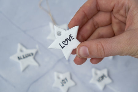 Christmas star with word LOVE Creator is using white air dry clay for making decor to Christmas tree...