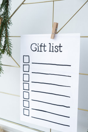 Preparation for winter holidays. GIFT LIST text on paper note. Celebration gifts and presents preparing Natural zero waste homemade Christmas decor. Happy new yearの写真素材