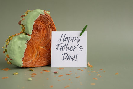 HAPPY FATHERS DAY saying words greeting card Delicious fresh croissant topped with Matcha Green Tea flavor Ganache. Creation unique heart shape bakery. Puff pastry holiday love gift present ideaの写真素材