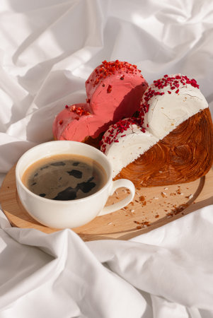 Morning breakfast in bed in wooden tray Present gift idea Valentines Day Holiday celebration Heart shaped croissants. Puff pastry new trendy sweet dessert bakery. Creamy doughの写真素材