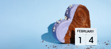 Calendar date 14 February greeting card Delicious fresh croissant topped with colorful flavor Ganache. Creation unique heart shape bakery. Puff pastry holiday love gift present idea Valentines dayの写真素材