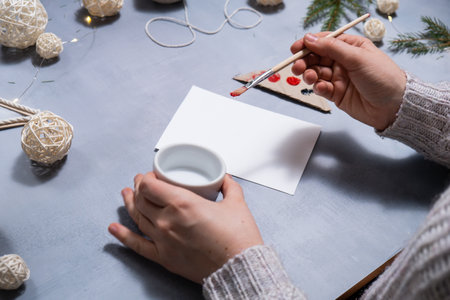 Christmas ball Storytelling of creating craft Christmas greeting card holiday present. Tactile hand-on activity. Master class progress of creative me-made gifts. Seasonal domestic life micro moment hobby.の写真素材