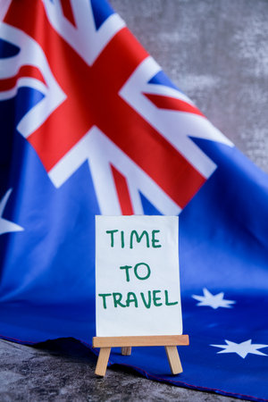 Australian flag and text TIME TO TRAVEL perfect for tourism or vacation advertising. Concept of wanderlust and national adventure use in travel guidesの写真素材