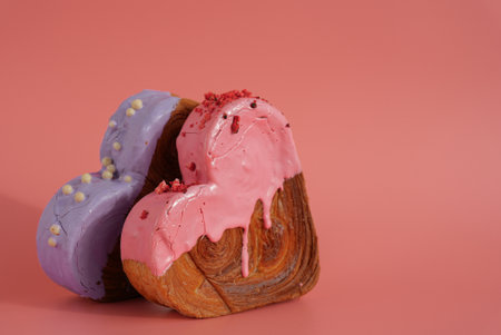 Delicious fresh croissant topped with colorful flavor Ganache. Creation unique heart shape bakery. Puff pastry holiday love gift present idea Valentines dayの写真素材