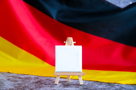 Empty white paper frame National symbol of Germany. Mock up advertisement template German wave Germany fabric flag background. Copy space for your text. Independenceの写真素材