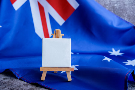 Mock-up for custom copy designs. Clean empty message board next to Australian flag. Place your logo or text on the white paper board next to the Australian flag. Modern mock-up template with national theme. Concept of blank canvas patriotism ready for customizationの写真素材