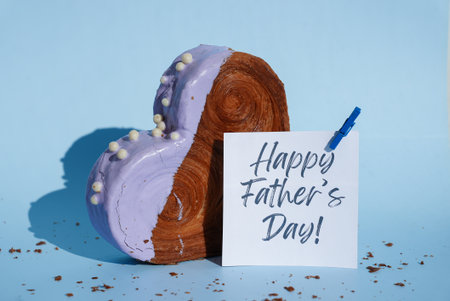 Happy Fathers Day saying caption on greeting card Delicious fresh croissant topped with colorful flavor Ganache. Creation unique heart shape bakery. Puff pastry holiday love gift present ideaの写真素材