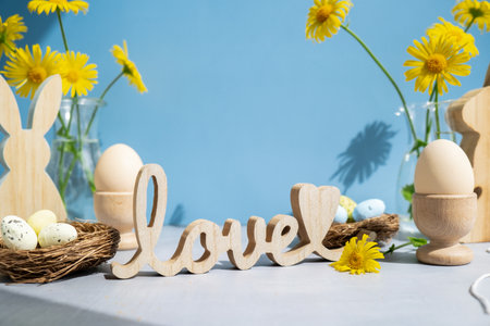 LOVE wooden word on festive blue background and eco-friendly zero waste natural decoration. Yellow...