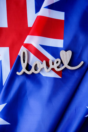 Wooden word LOVE on background of National symbol of Australia flag background. Copy space for your text. Conceptの写真素材