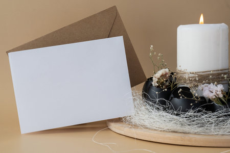 White empty paper note template mock up postcard copy space Easter holiday decoration from sustainable materials egg shell decor with candle. Diy do it yourself step by step instruction. Gift present idea Crafting preparationの写真素材