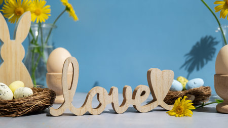 Wooden word LOVE traditional greeting to christian holiday. Festive mood composition with bunnies...