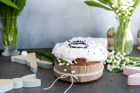 Traditional tasty sugar glazed Easter cake with decoration fresh flowers Easter eggs. Happy Easter...