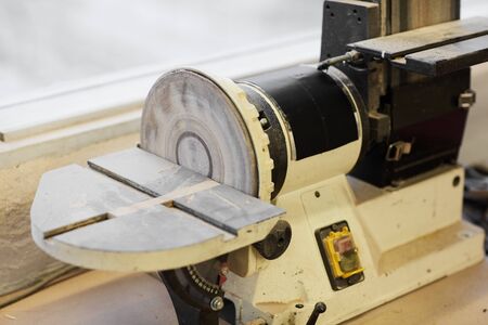 Close-up of electric saw for wooden details at work place in workshopの写真素材