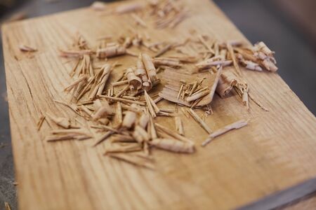 Close-up of wooden sawdust on the wooden board in workshopの写真素材
