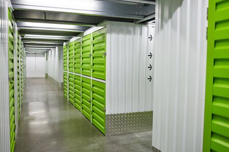 Image of empty warehouse with green chambers for boxesの写真素材