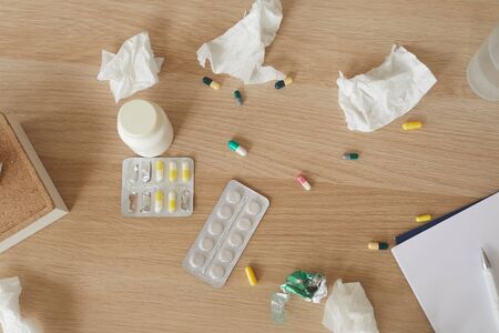 Close-up of pills and bottle with medicine on the wooden table they are for health or mental healthの写真素材