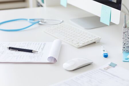 Close-up of medical card on the table with other medical supplies at the hospitalの写真素材