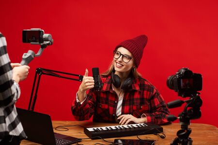 Young smiling woman showing thumb up to the camera she making contentの写真素材