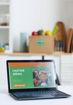 Close-up of laptop computer on the table with website of local food deliveryの写真素材