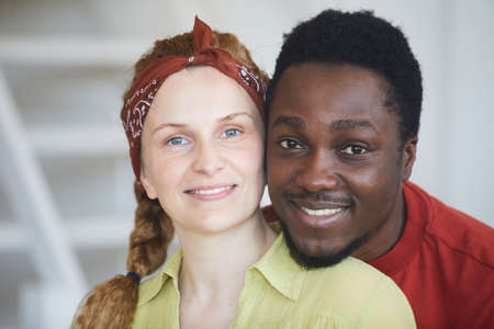 Portrait of multiracial young couple smiling at cameraの写真素材