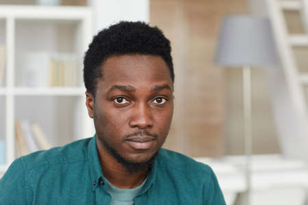 Portrait of African young man in shirt looking at camera