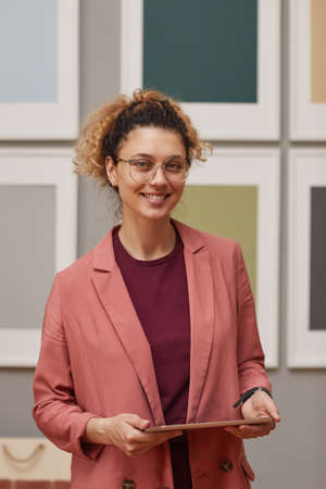Portrait of female designer using digital tablet in her work she working at art gallery