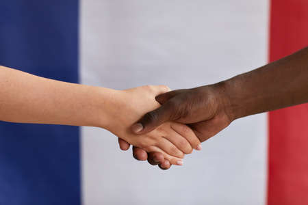 Close-up of multiethnic people greeting each other and shaking handsの写真素材