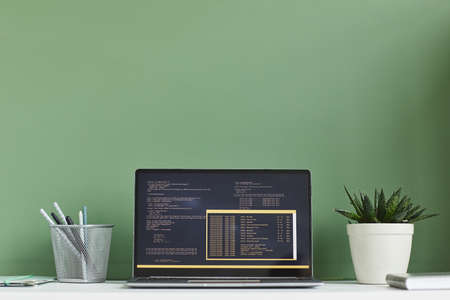 Image of laptop with software on the screen at workplace at office