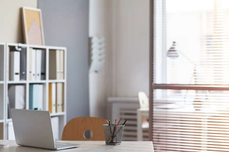 Image of workplace with laptop for office workers at empty office