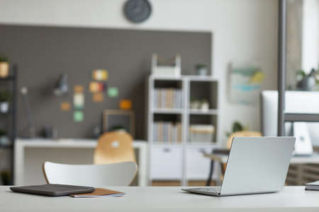Image of table with laptop and digital tablet on it for online work at officeの写真素材
