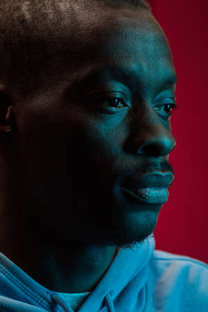 Close-up of African man isolated on pink background