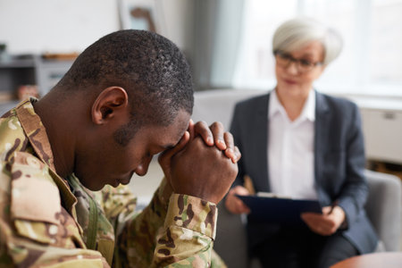 African soldier has a depression while visiting his psychologist at officeの写真素材