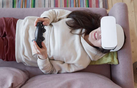 Woman wearing virtual reality headset at home