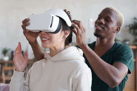 Man showing virtual reality to womanの写真素材