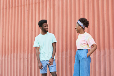 African young people talking to each other while standing outdoorsの写真素材
