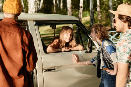 Group of happy friends talking to each other while standing outdoors they discussing their journey