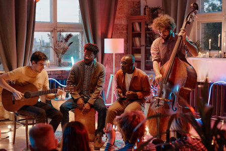 Musical band playing on different musical instruments and singing while performing for people in the clubの写真素材
