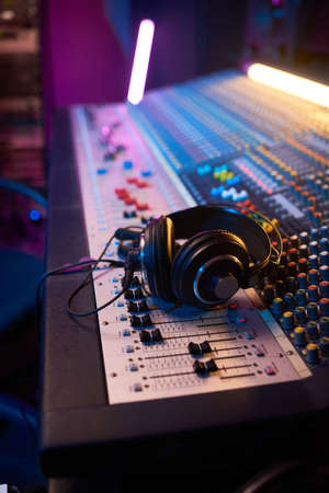 Close-up of boutique recording studio control desk with headphones on it in the recording studioの写真素材