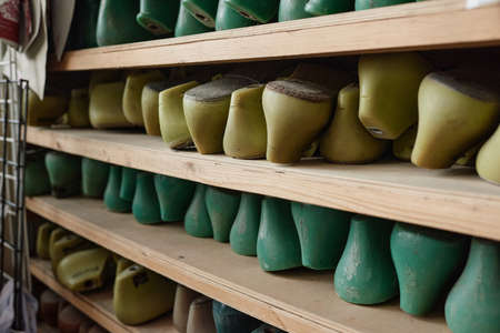 Close-up of wooden last on the shelves for creation of new shoes in the factory